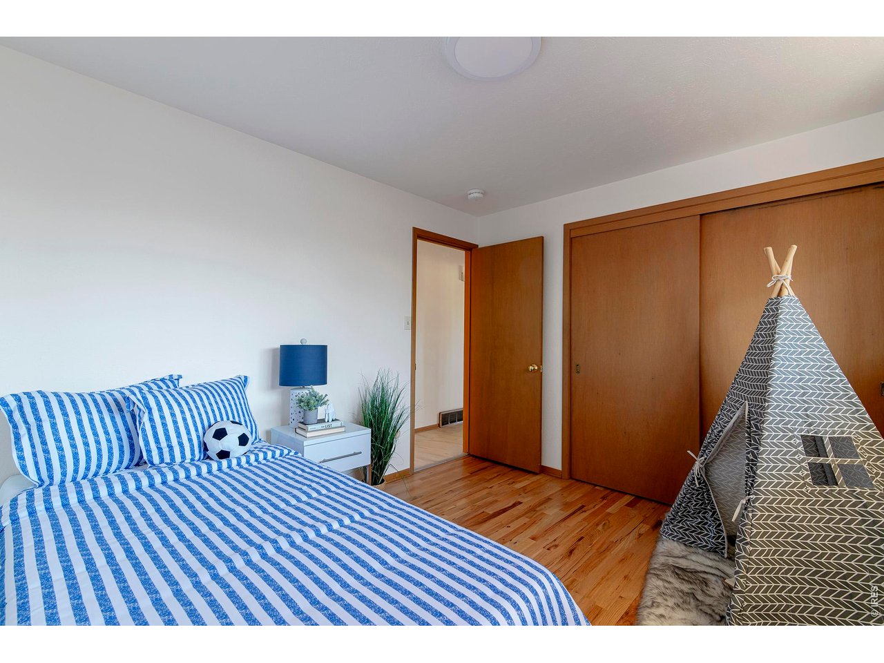 2410 Grape Avenue Boulder, CO 80304 - Photo 26 of 50 Secondary bedroom 3 featuring a spacious double closet, refinished hardwood floors, and fresh paint that brightens and refreshes the space.