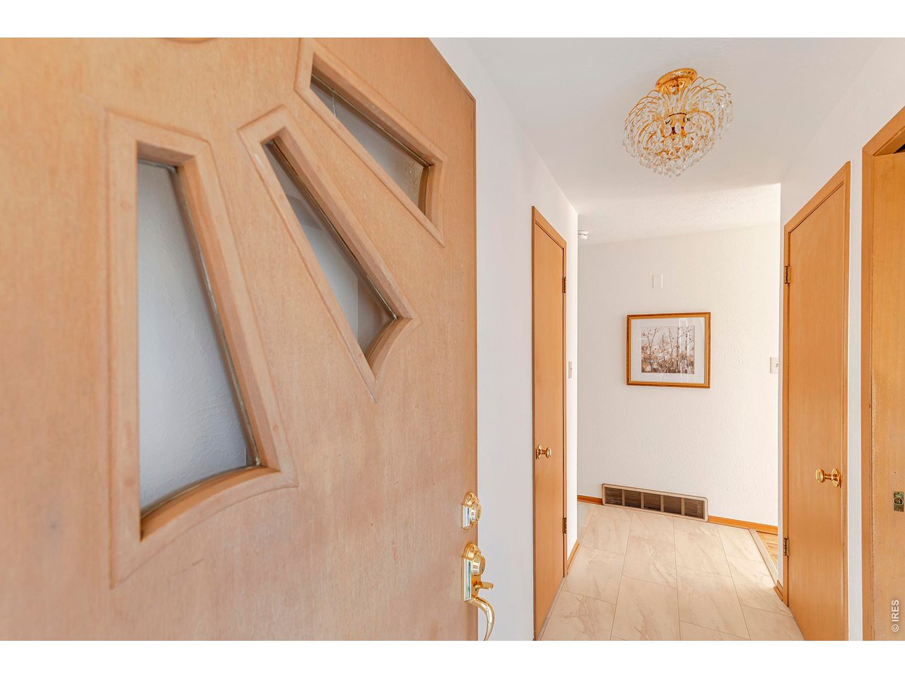 2410 Grape Avenue Boulder, CO 80304 - Photo 34 of 50 This front door makes a subtle architectural statement the moment you arrive. Crafted in warm, natural wood, it features three geometric, diamond-shaped glass insets arranged vertically - a distinctive mid-century detail