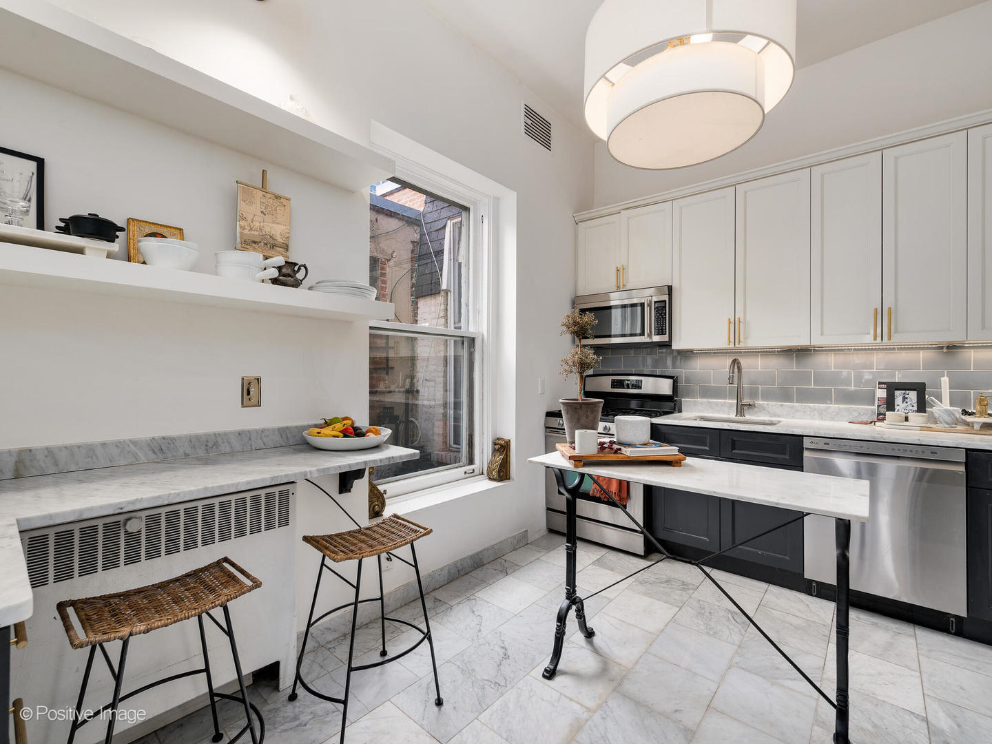 1450 North Dearborn Street, Unit 3A Chicago, IL 60610 - Photo 7 of 17 a kitchen with stainless steel appliances kitchen island granite countertop a sink and cabinets