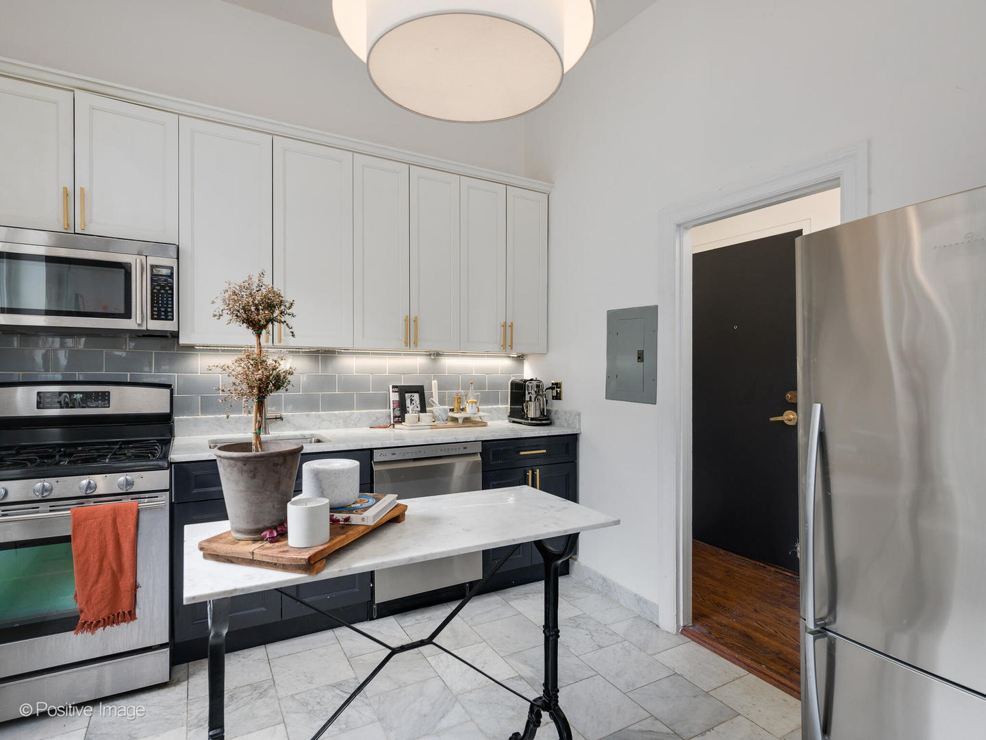 1450 North Dearborn Street, Unit 3A Chicago, IL 60610 - Photo 9 of 17 a kitchen with stainless steel appliances granite countertop a refrigerator and a stove top oven