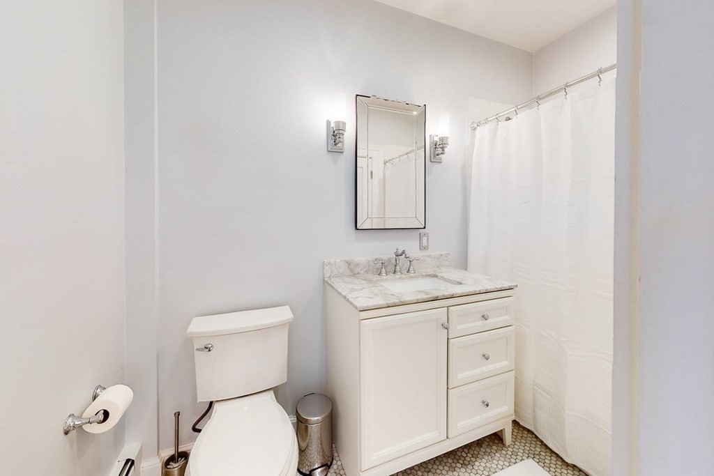 32 Mead Boston Ma, Unit 2 Boston, MA 02129 - Photo 15 of 21 a bathroom with a granite countertop sink toilet and mirror
