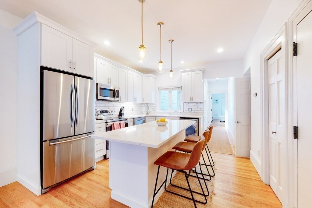 32 Mead Boston Ma, Unit 2 Boston, MA 02129 - Photo 8 of 21 a kitchen with stainless steel appliances granite countertop a refrigerator a sink dishwasher a stove and a refrigerator with wooden floor