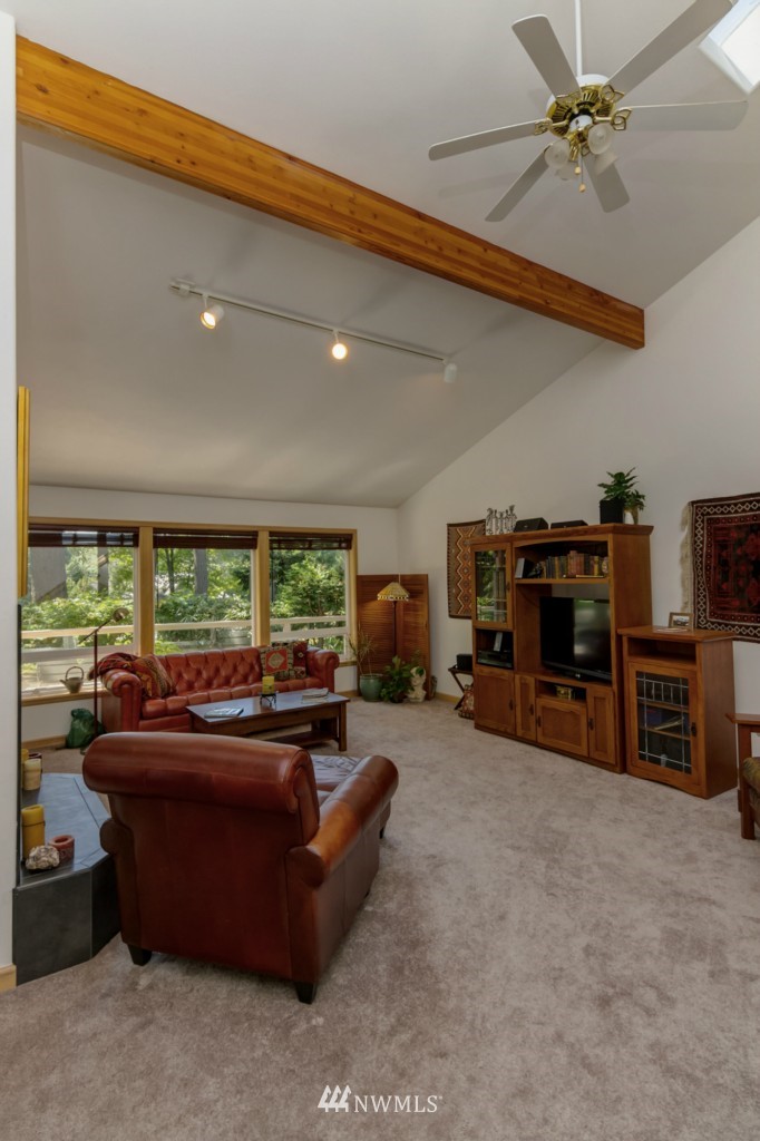 5500 Canvasback Road Blaine, WA 98230 - Photo 13 of 23 a living room with furniture a fireplace and a flat screen tv