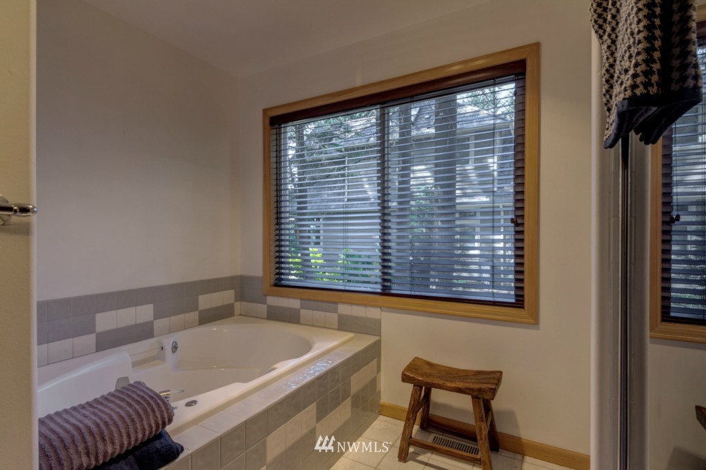 5500 Canvasback Road Blaine, WA 98230 - Photo 16 of 23 a bath tub sitting in a bathroom next to a window