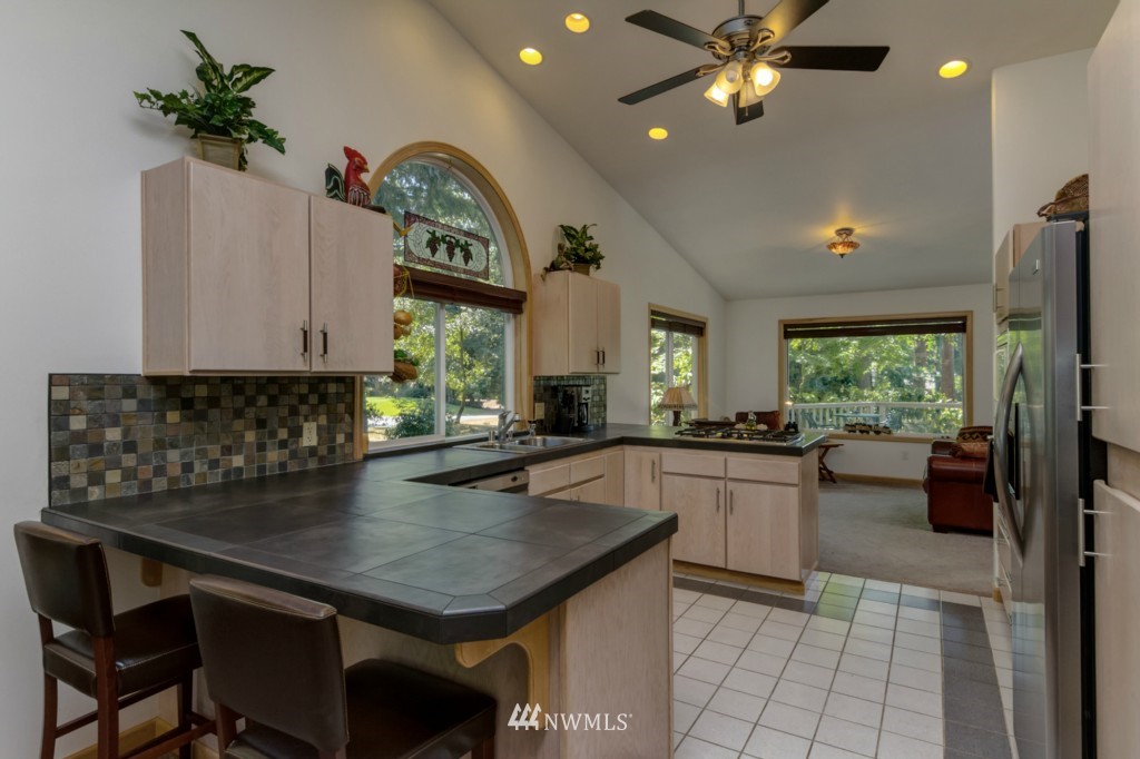 5500 Canvasback Road Blaine, WA 98230 - Photo 3 of 23 a kitchen with a table chairs and microwave