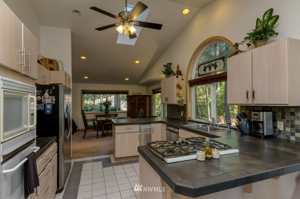 5500 Canvasback Road Blaine, WA 98230 - Photo 4 of 23 a kitchen with a stove a sink and a refrigerator