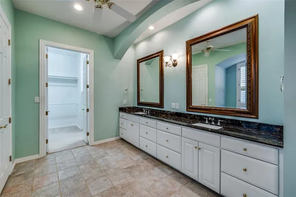 a bathroom with double sink and a mirror