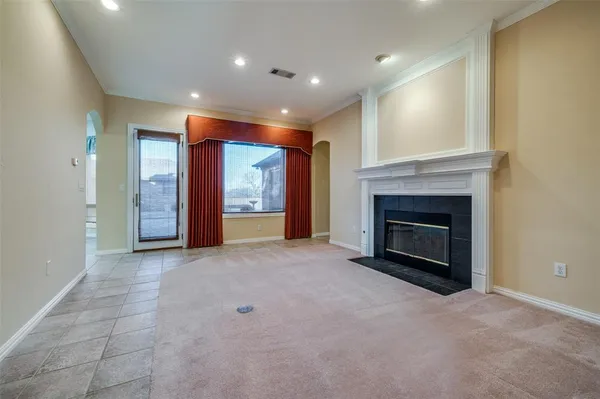 a view of an empty room with a fireplace
