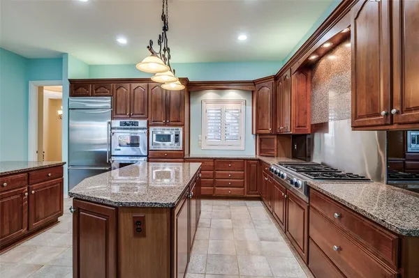 a kitchen with granite countertop a stove and a sink