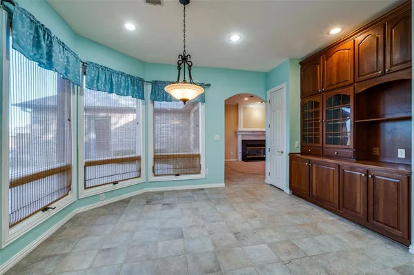 a view of a kitchen with refrigerator and a sink