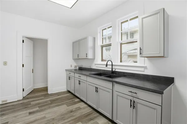 a kitchen with granite countertop a sink and cabinets