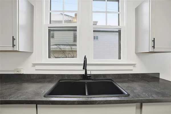 a kitchen with a sink and cabinets