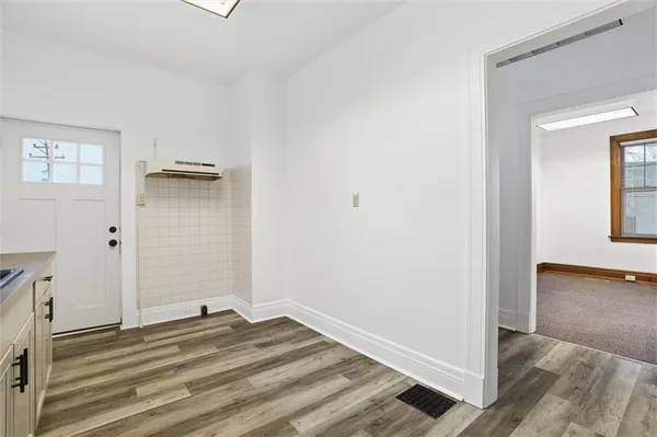 a view of a bedroom with wooden floor and closet
