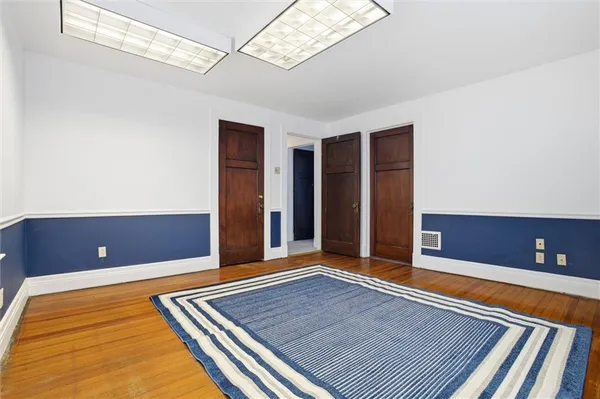 a view of an empty room with window and a ceiling fan