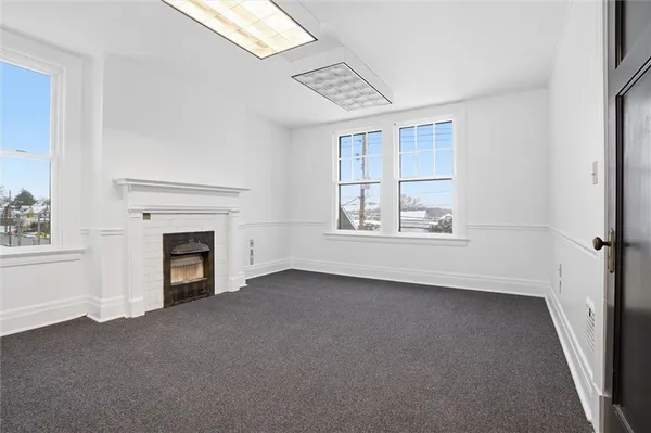 a view of empty room with fireplace