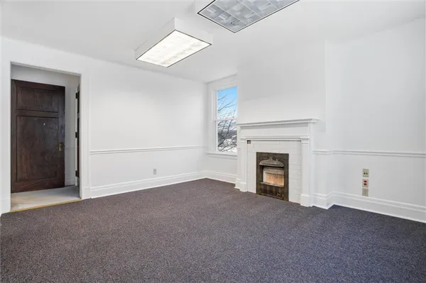 a view of empty room with a fireplace