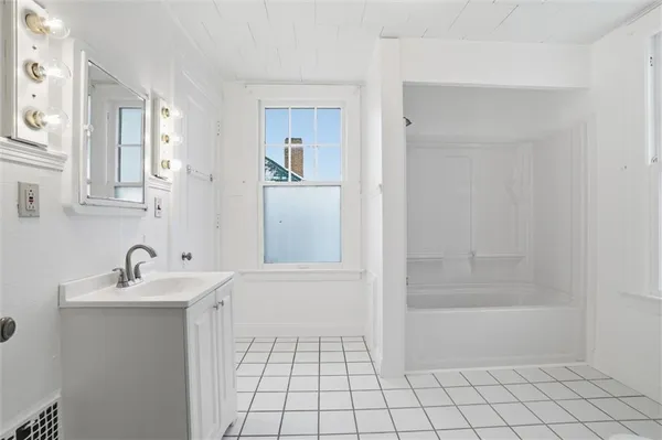 a bathroom with a sink a mirror and a shower