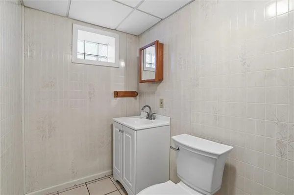 a bathroom with sink toilet and mirror