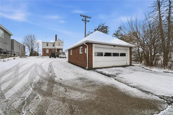 a view of a house with a snow in a backyard