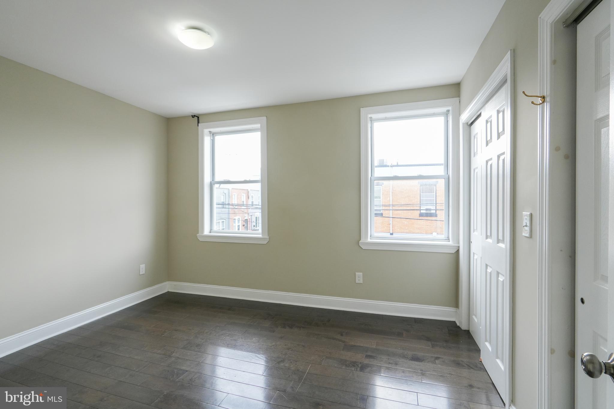 2633 Tasker Street Philadelphia, PA 19145 - Photo 12 of 23 an empty room with wooden floor and windows