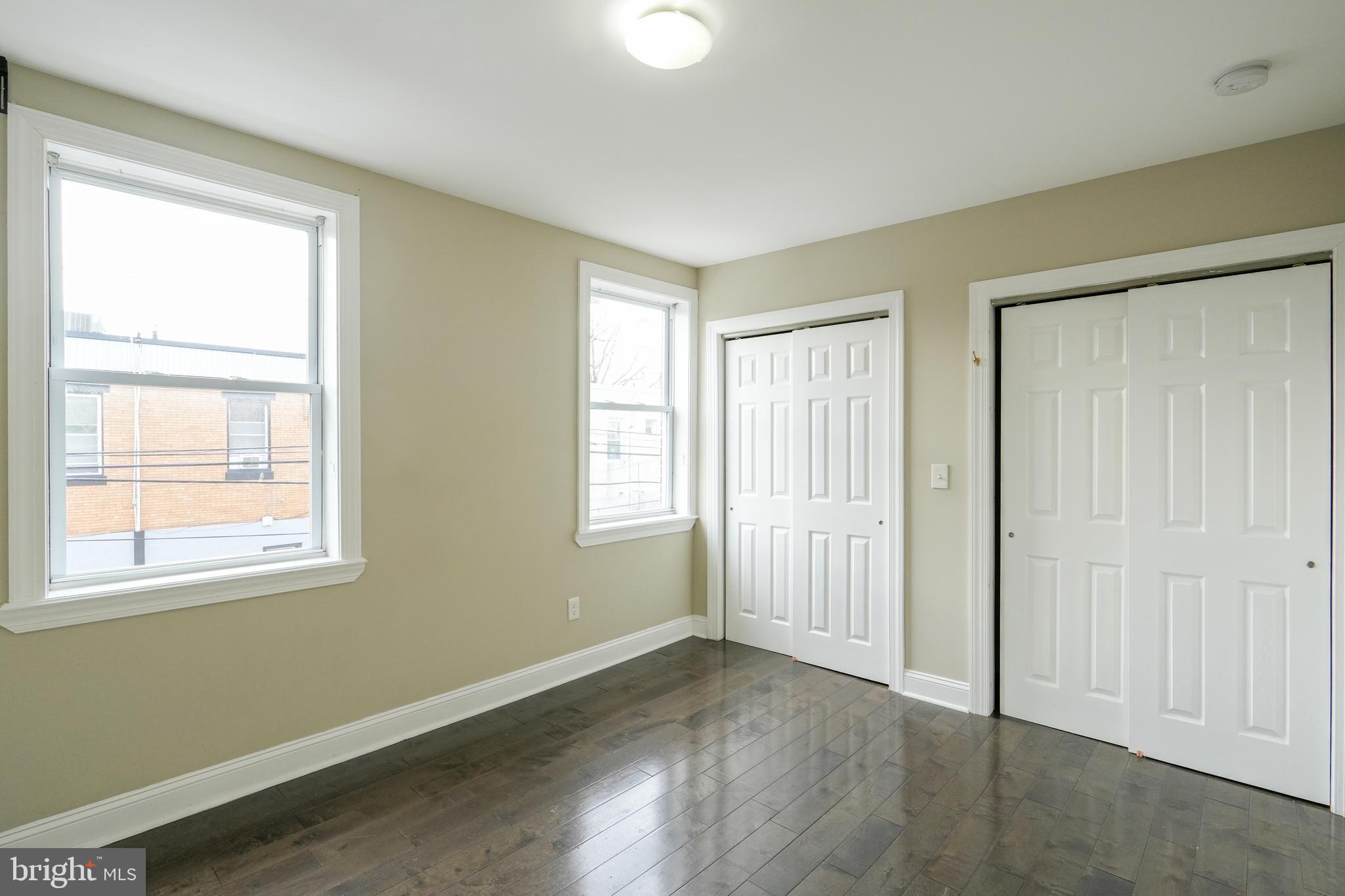 2633 Tasker Street Philadelphia, PA 19145 - Photo 14 of 23 an empty room with wooden floor and windows