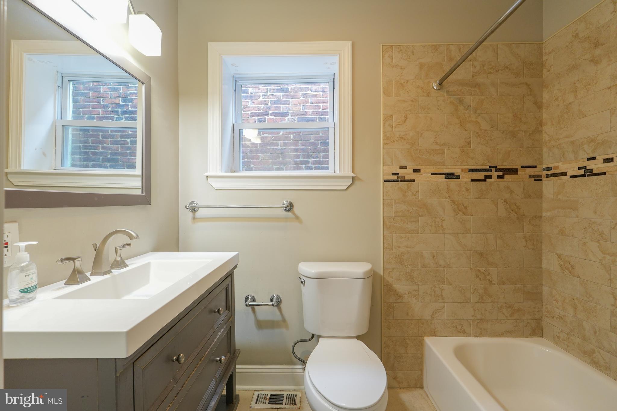 2633 Tasker Street Philadelphia, PA 19145 - Photo 17 of 23 a bathroom with a toilet a sink and a bathtub