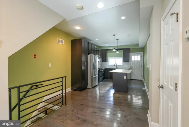 a kitchen with a refrigerator and a sink