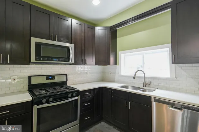 a kitchen with a sink stove and microwave
