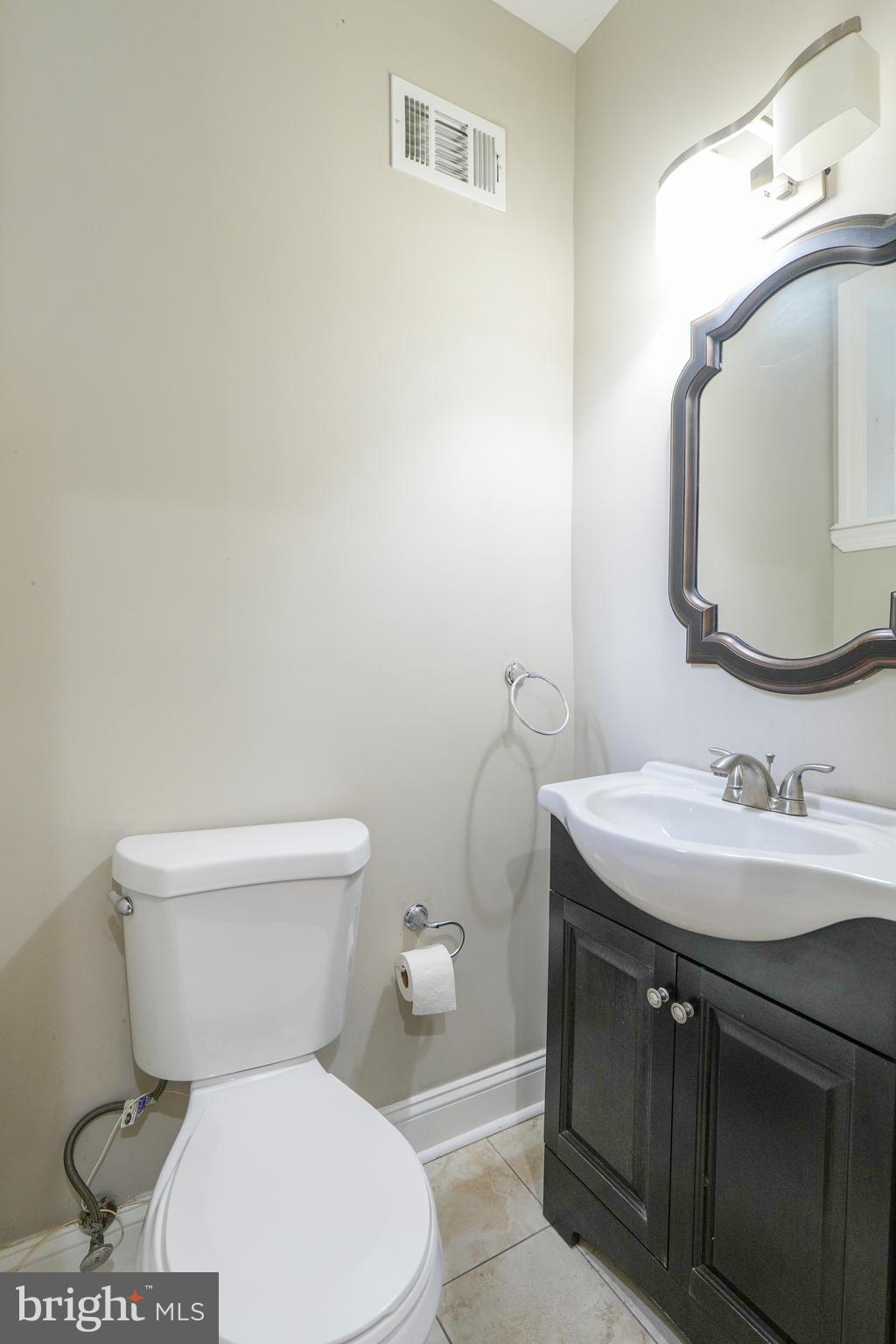 2633 Tasker Street Philadelphia, PA 19145 - Photo 10 of 23 a white toilet sitting next to a bathroom sink