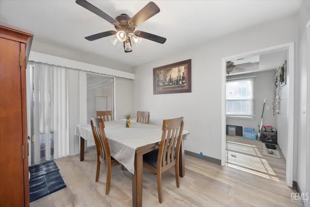 a kitchen with a sink dishwasher stove and white cabinets with wooden floor