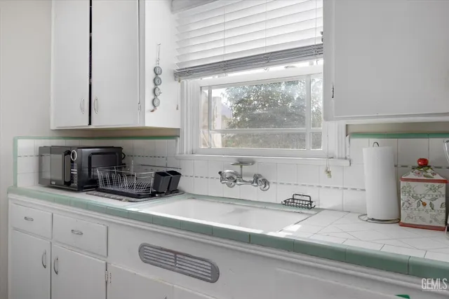 a kitchen with cabinets and appliances