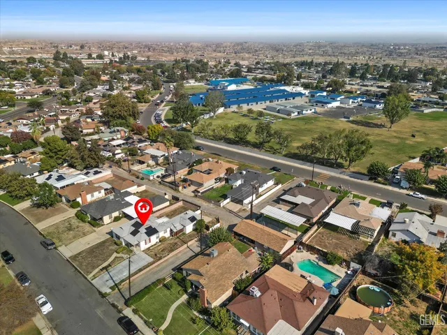an aerial view of a residential houses with city view
