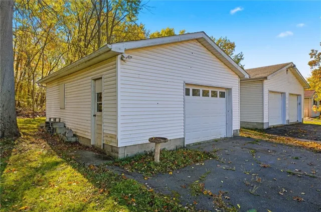 a view of a house with backyard and a tree