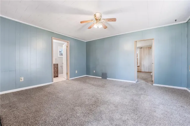 a view of an empty room with a ceiling fan