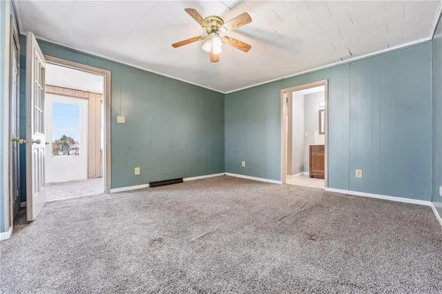 a view of a room with a chandelier fan and entryway