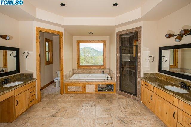 41167 Oak Ridge Drive Three Rivers, CA 93271 - Photo 9 of 27 a spacious bathroom with a granite countertop tub and a sink