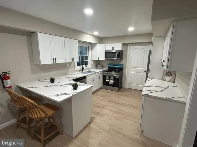 a kitchen that has a sink and a stove in it