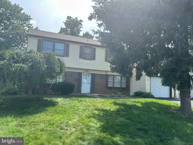 a view of a house with a yard and a garden