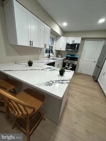 a kitchen with a sink a stove and cabinets
