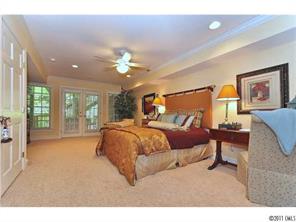 1502 Windy Ridge Road Charlotte, NC 28270 - Photo 12 of 15 a spacious bedroom with a bed painting on wall and a large window