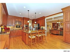 1502 Windy Ridge Road Charlotte, NC 28270 - Photo 5 of 15 a kitchen with stainless steel appliances kitchen island granite countertop a table and chairs