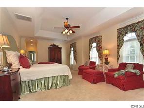 1502 Windy Ridge Road Charlotte, NC 28270 - Photo 8 of 15 a bedroom with a bed ceiling fan and a window