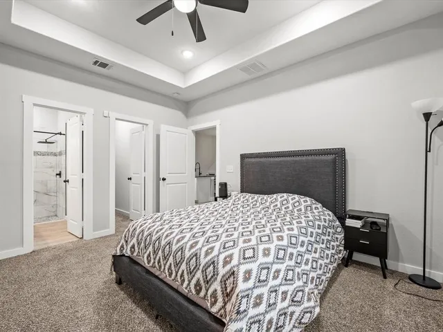 a bedroom with a bed and a chandelier