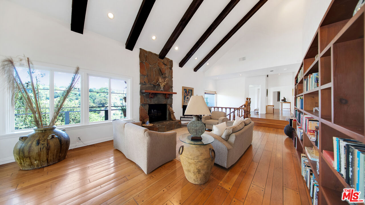2312 Kimridge Road Beverly Hills, CA 90210 - Photo 22 of 60 a living room with furniture fireplace and a large window