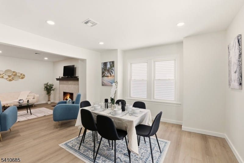 338 East 19th Street Paterson, NJ 07524 - Photo 11 of 30 a view of a dining room with furniture and wooden floor