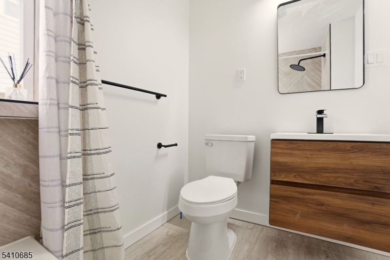 338 East 19th Street Paterson, NJ 07524 - Photo 19 of 30 a bathroom with a toilet and a sink