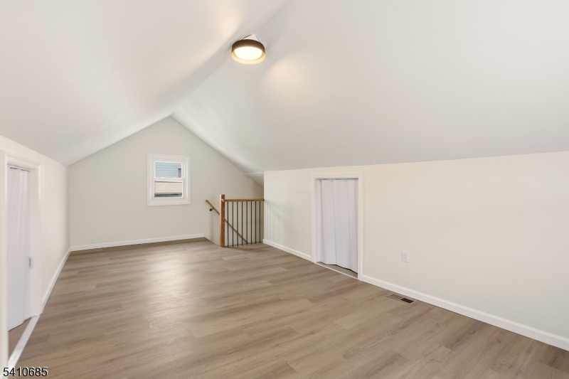 338 East 19th Street Paterson, NJ 07524 - Photo 20 of 30 a view of an empty room with wooden floor and a window
