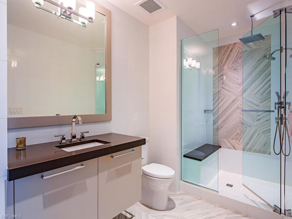 490 5th Street South, Unit 101 Naples, FL 34102 - Photo 18 of 34 a bathroom with a sink toilet and shower