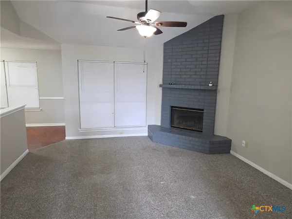 a view of empty room with fireplace