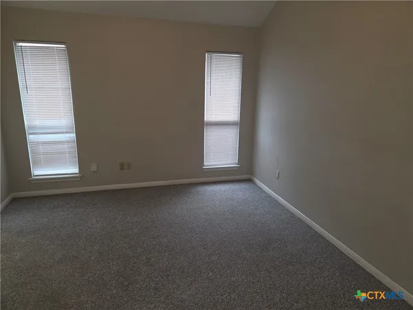 a view of empty room with windows